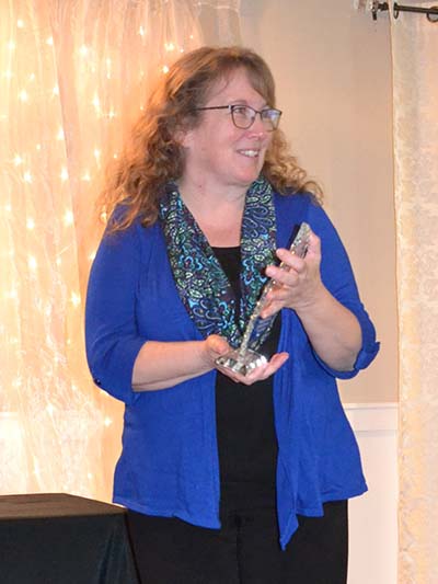 lady holding award