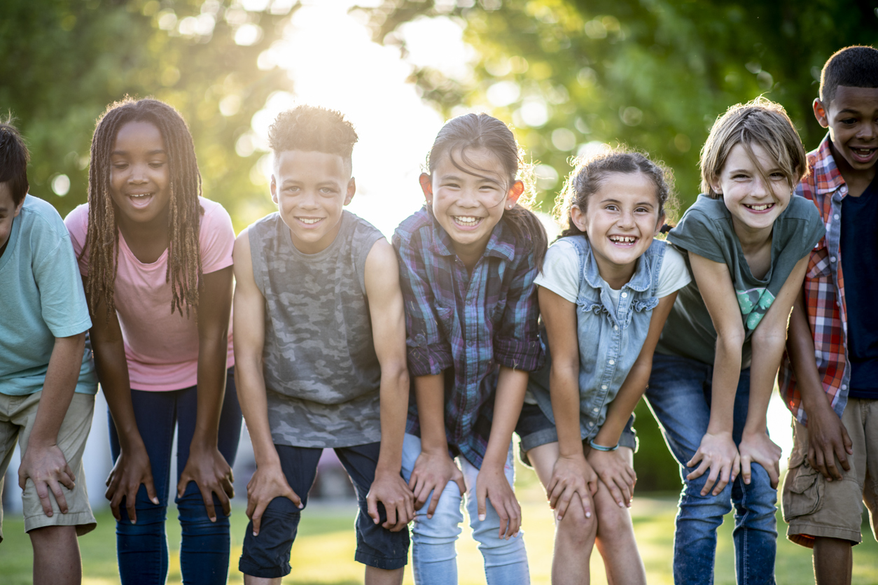 A group of smiling children outdoors